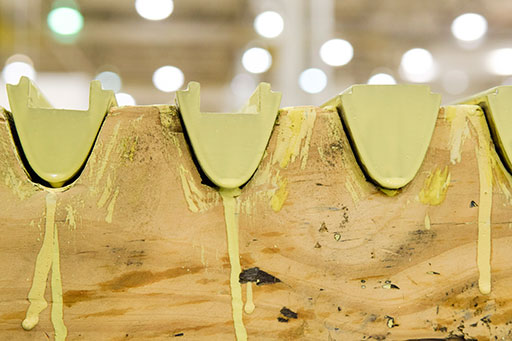 Newly painted KC-135 Stratotanker ruddervator weights sit in a cradle to dry as they are prepared for use by the 553rd Commodities Maintenance Squadron at the Oklahoma City Air Logistics Complex, July 25, 2016, Tinker Air Force Base, Okla. The yellow zinc-chromate is used to prevent corrosion on metal surfaces.  (U.S. Air Force photo/Greg L. Davis)