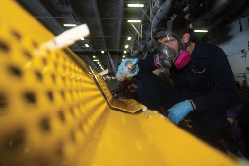Corrosion is an expensive problem. The combined  U. S. military recorded  $10.2 billion in corrosion costs for their aviation and missile fleets in fiscal year 2016. Shown here is Aviation Support Airman Tanner Freeman, from Indianapolis, applying an anti-corrosion treatment to a panel in the hangar bay aboard the Nimitz-class aircraft carrier USS John C. Stennis. U.S. Navy image by Mass Communication Specialist 3rd Class Grant G. Grady.