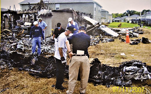 NTSB Vice Chairman Robert Sumwalt (left) surveys the accident site with air safety investigator Mike Huhn, who led the Maintenance Records Group. (NTSB Photo)