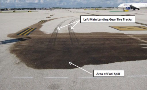 Graphic 3. A puddle of fuel with tire tracks from the airplane provided more clues for investigators. NTSB Photo.