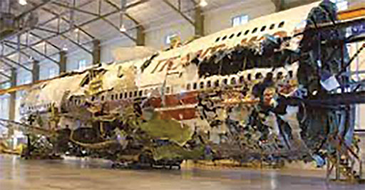 The 3-dimensional reconstruction of the wreckage from TWA flight 800 is currently housed at the NTSB Training Center.  The reconstruction assisted investigators in determining that the center wing fuel tank exploded, likely due to deteriorated wiring in the fuel quantity indicating system (FQIS)