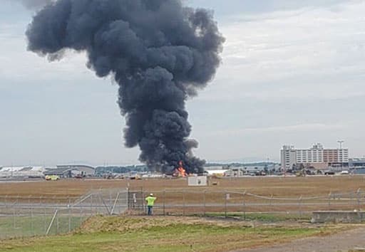 Photo 4: A plume of smoke rises above the location where the Nine-O-Nine crashed at Bradley International Airport in Connecticut.