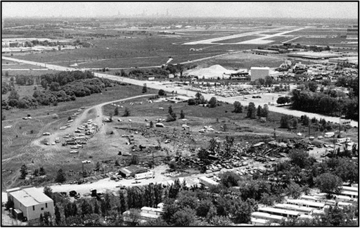 Graphic 3 – Aerial view showing the accident site of Flight 191.  The departure runway (runway 32R) can be seen in the background.