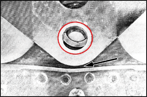 Graphic 10 – Close-up view of deformation of the pylon bulkhead flange from an exemplar aircraft that utilized the “shortcut” method of changing out the bearings. The red circle shows how a misalignment can occur with the wing clevis when a forklift is used to support the engine/pylon assembly.  The forks can rotate or move over time during maintenance to cause this misalignment.