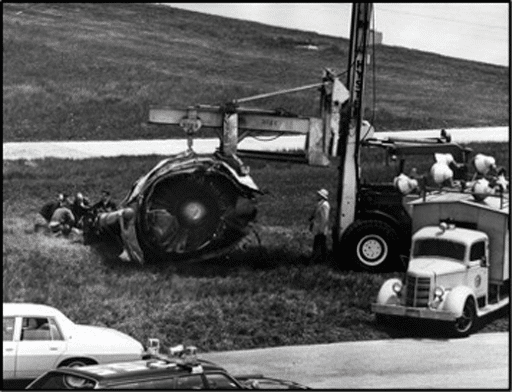 Graphic 4 – Photo showing the no. 1 (left) engine that separated from the doomed DC-10.  The engine rolled over the top of the left wing during takeoff and was found next to the departure runway.